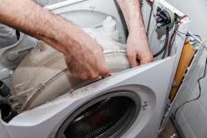 Technician repairing a washing machine